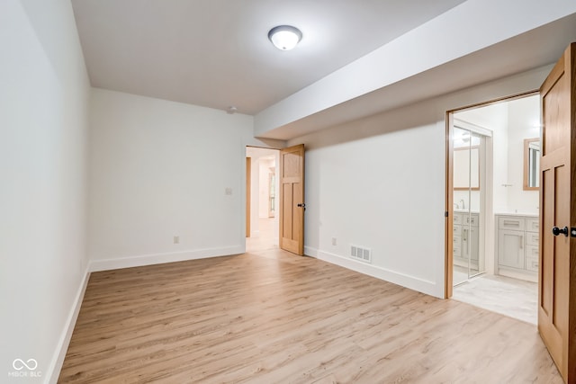 interior space with visible vents, light wood finished floors, and baseboards