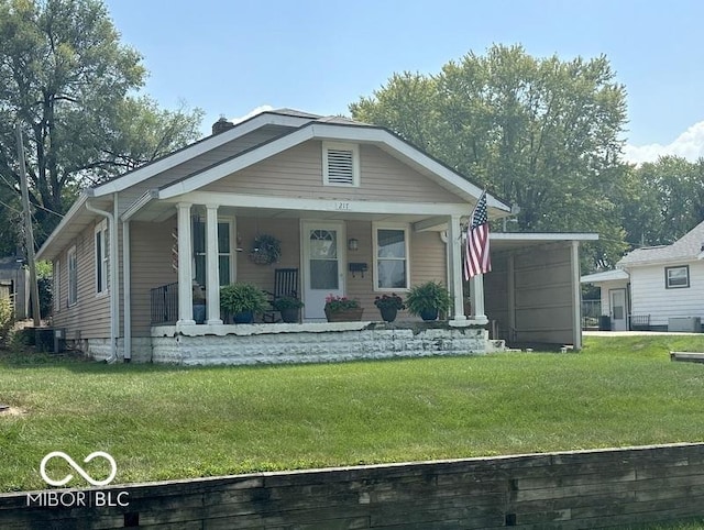 bungalow with covered porch, a chimney, and a front yard