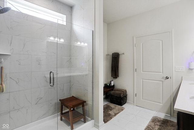 bathroom featuring a shower with door and vanity