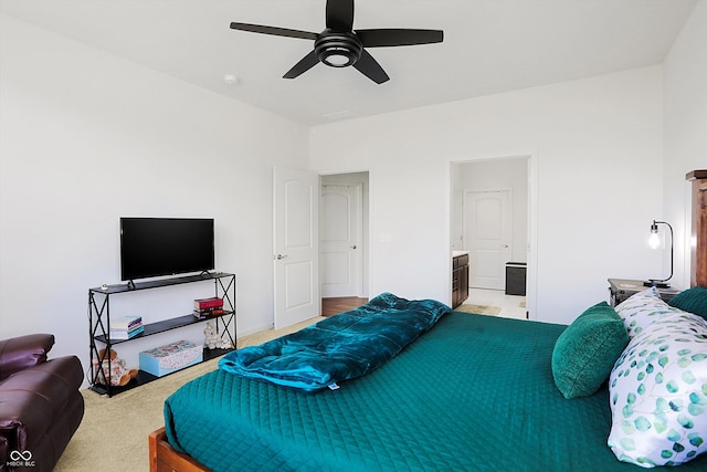 carpeted bedroom featuring ceiling fan and ensuite bathroom