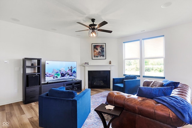 living room with ceiling fan and light hardwood / wood-style floors