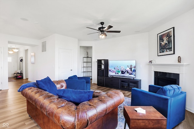 living room with ceiling fan and wood-type flooring