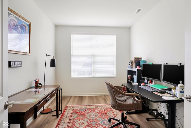 office space with light hardwood / wood-style flooring and a wealth of natural light