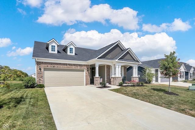 view of front facade featuring a garage, a front lawn, and covered porch