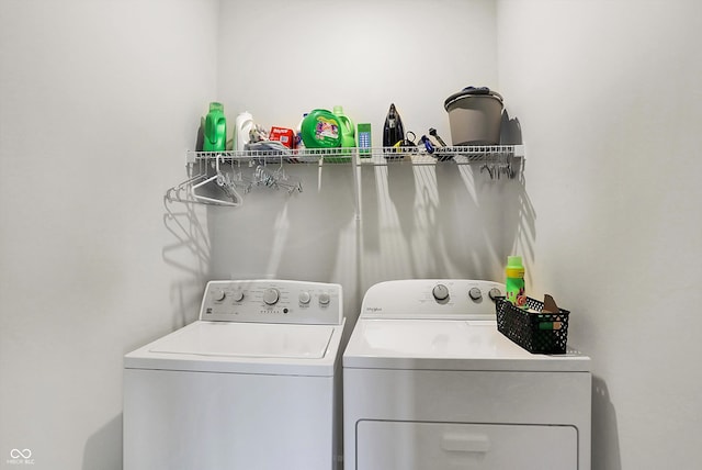 clothes washing area with separate washer and dryer