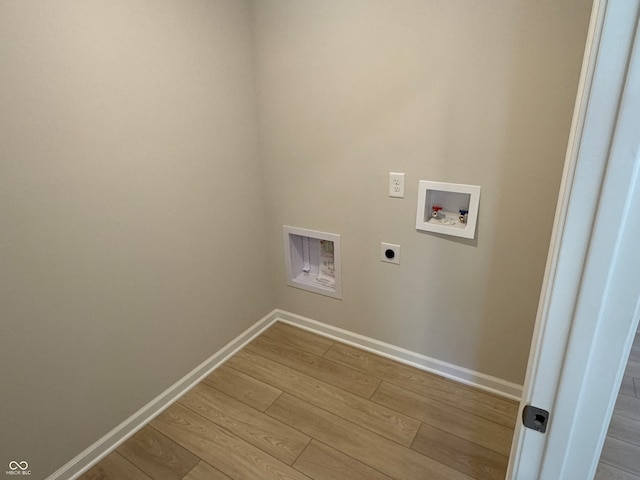 clothes washing area featuring light wood-type flooring, hookup for an electric dryer, and hookup for a washing machine