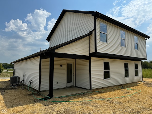 rear view of house with a patio and central air condition unit