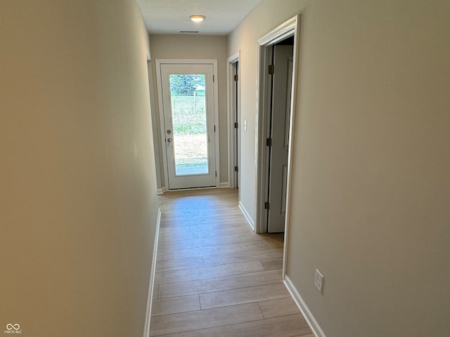 corridor with light wood-type flooring