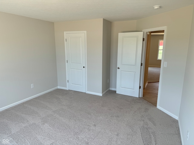 unfurnished bedroom with light carpet