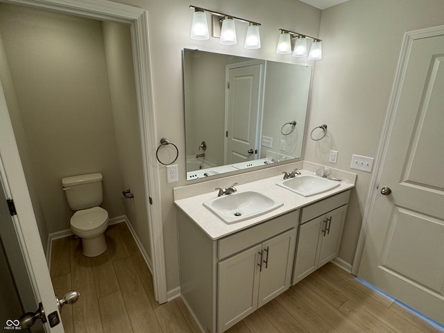 bathroom with vanity, hardwood / wood-style floors, and toilet