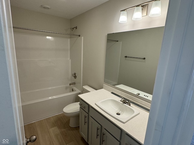 full bathroom with tub / shower combination, vanity, toilet, and hardwood / wood-style flooring