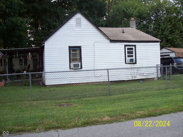 view of side of home with a yard and cooling unit