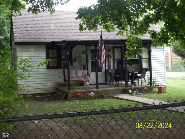 exterior space with a porch and a front yard