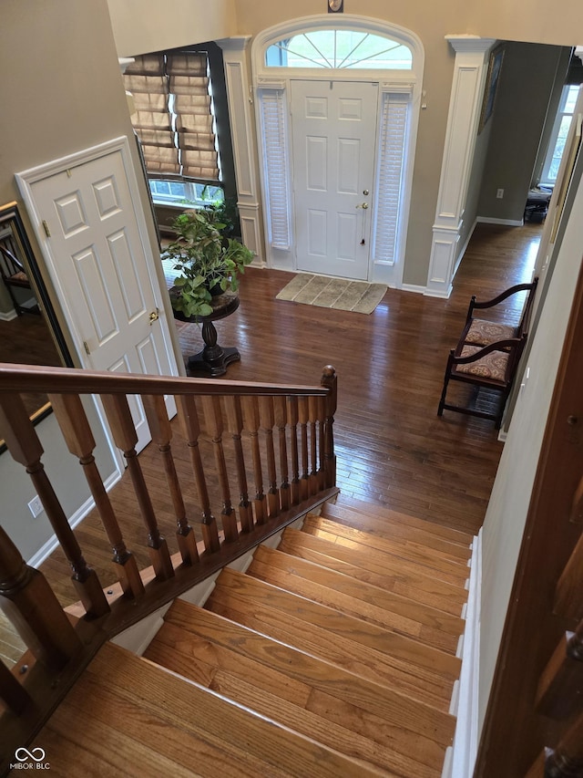 entryway featuring stairway, baseboards, and hardwood / wood-style flooring