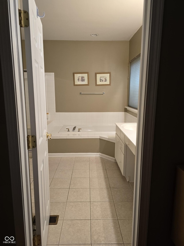 full bathroom with tile patterned flooring, vanity, and a garden tub