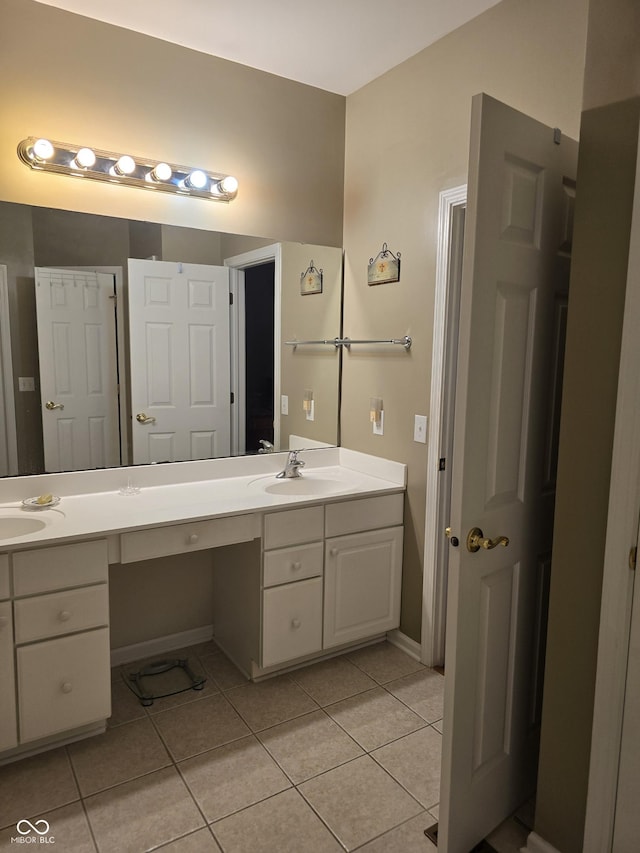 bathroom with a sink, double vanity, and tile patterned floors