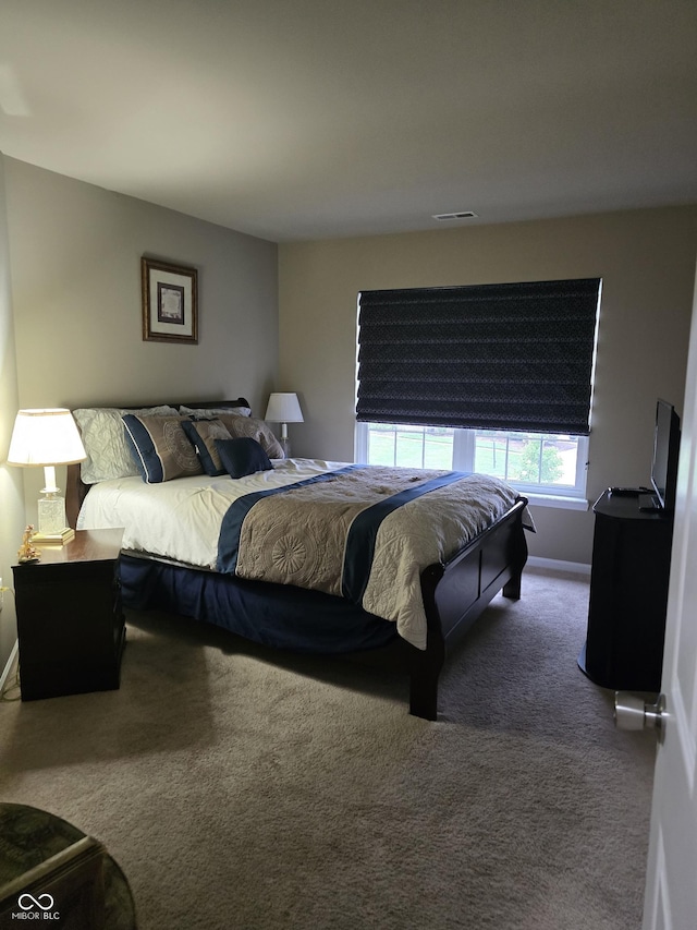 bedroom featuring carpet, visible vents, and baseboards