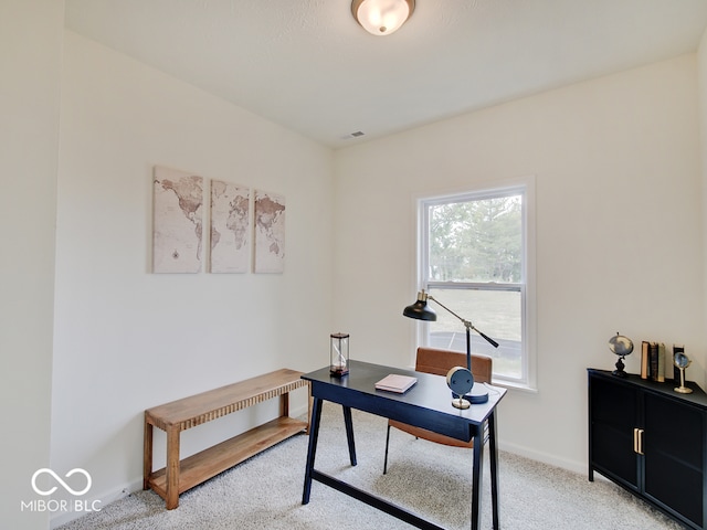 office space with light carpet, baseboards, and visible vents