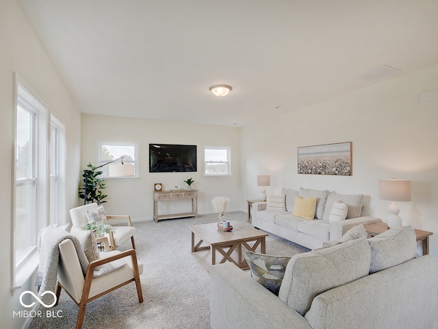 living room with light carpet and baseboards