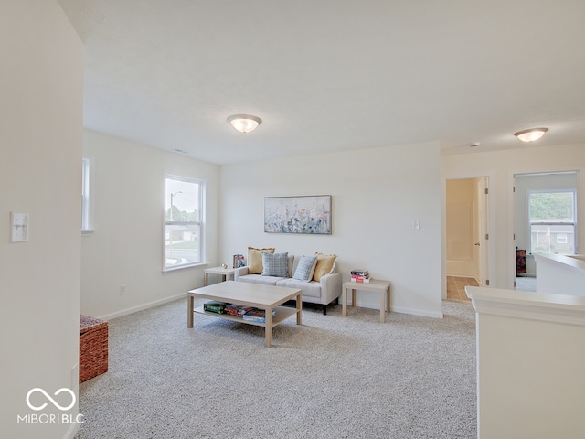 carpeted living room with baseboards