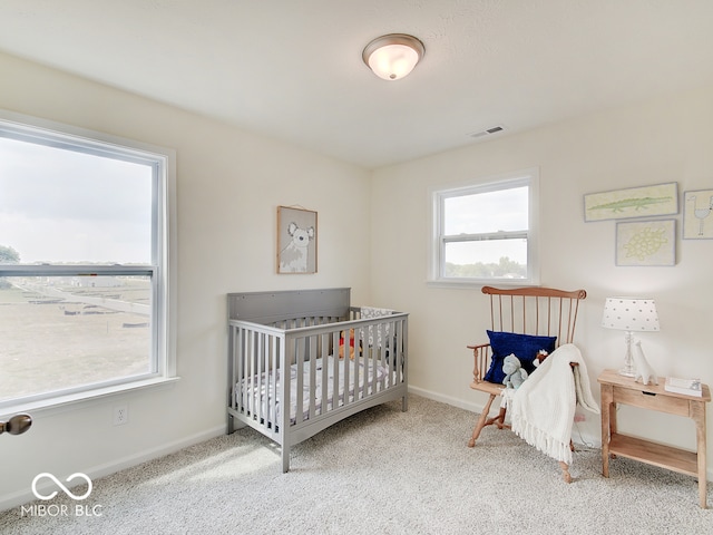 bedroom with carpet, visible vents, and baseboards