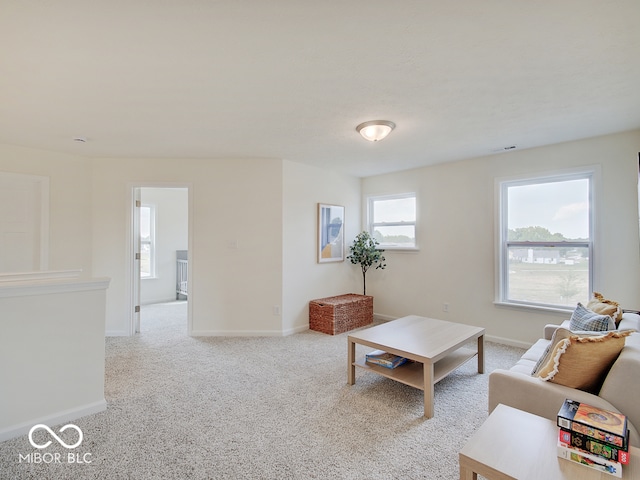 carpeted living room with baseboards