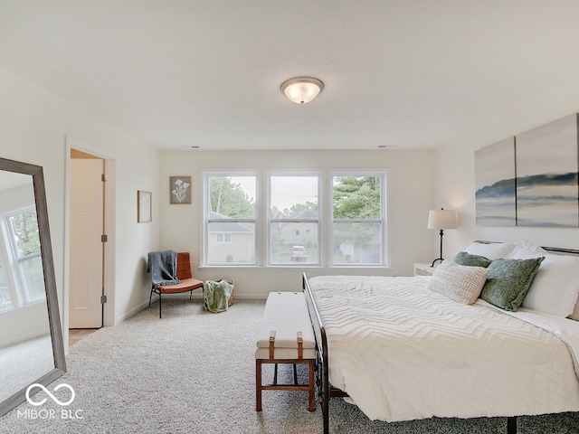 bedroom with carpet flooring and baseboards