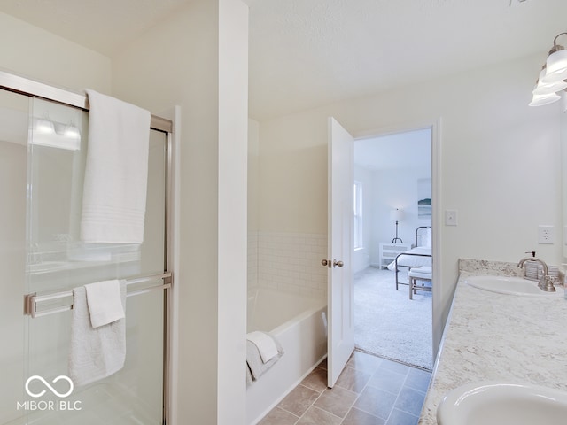 full bath featuring a stall shower, a garden tub, a sink, and double vanity