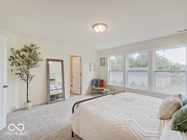 carpeted bedroom featuring visible vents and baseboards