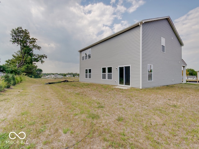 back of house with a yard