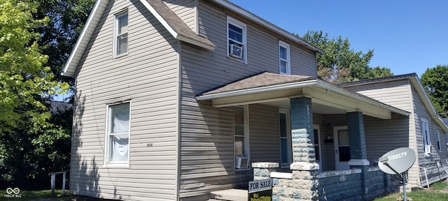 view of side of property with a porch