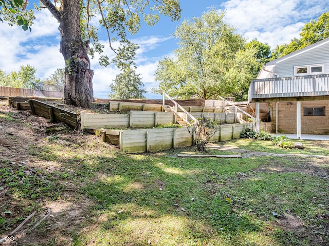 view of yard with a patio area, a fenced backyard, and a vegetable garden