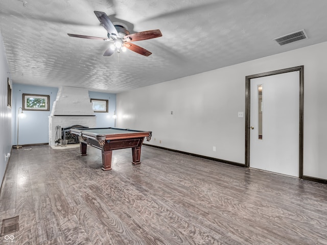 playroom with a fireplace, billiards, a textured ceiling, wood-type flooring, and ceiling fan