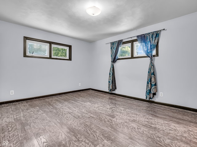 empty room with hardwood / wood-style floors