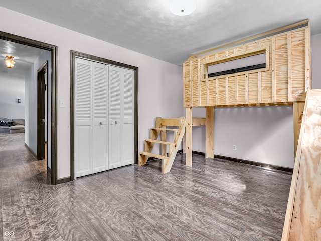 bedroom with a closet and dark hardwood / wood-style flooring