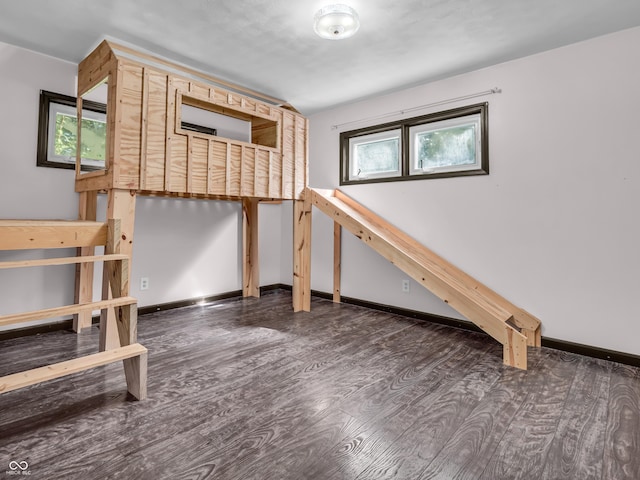 unfurnished bedroom with dark wood-style floors and baseboards