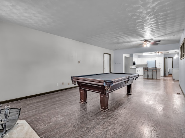 game room with a textured ceiling, ceiling fan, pool table, and wood-type flooring