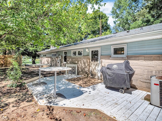 wooden deck with area for grilling and fence