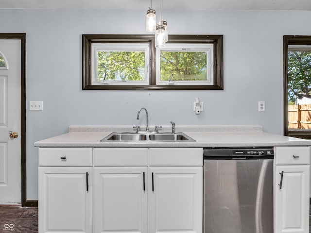 kitchen featuring a sink, white cabinets, light countertops, and dishwasher