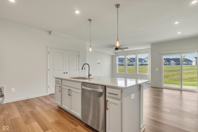 kitchen featuring white cabinetry, sink, an island with sink, ceiling fan, and stainless steel dishwasher