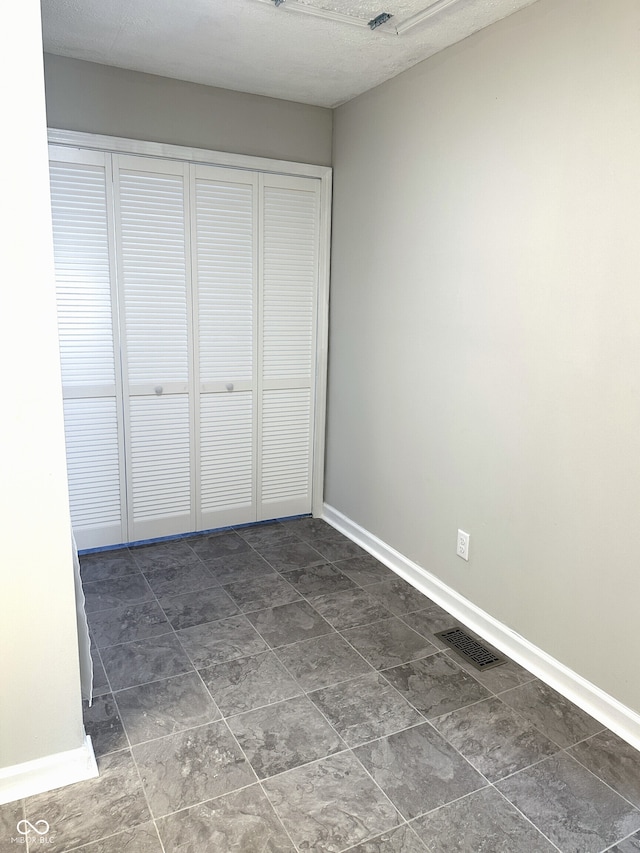 unfurnished bedroom with a closet