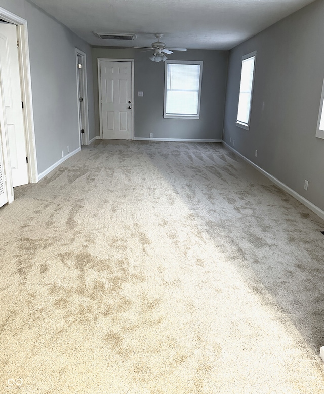 unfurnished room featuring light carpet