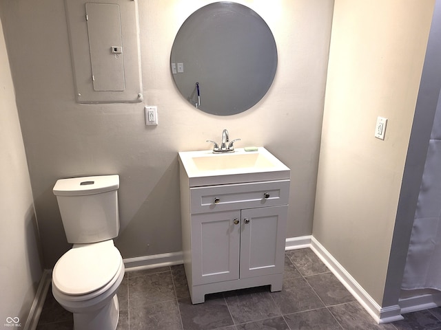 bathroom with tile patterned floors, vanity, toilet, and electric panel