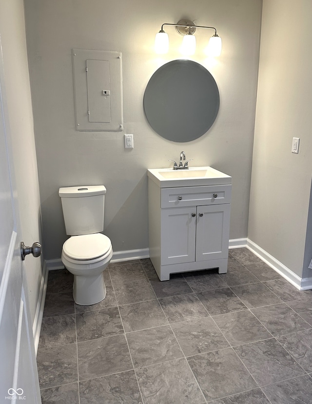 bathroom featuring vanity, electric panel, and toilet