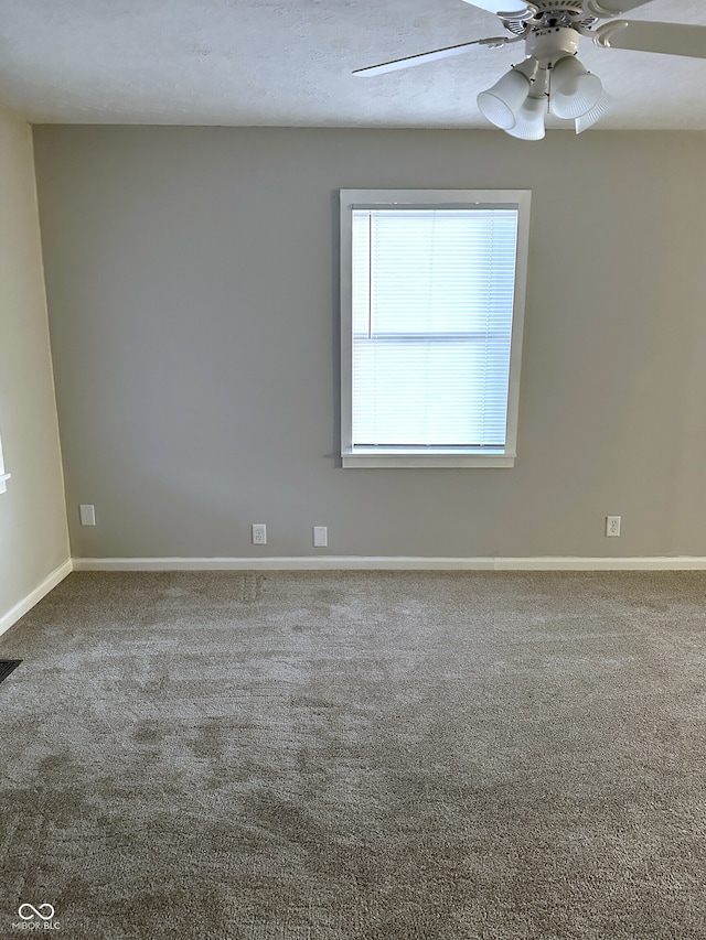 carpeted empty room featuring ceiling fan