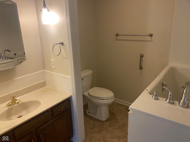 bathroom featuring vanity, toilet, and a tub