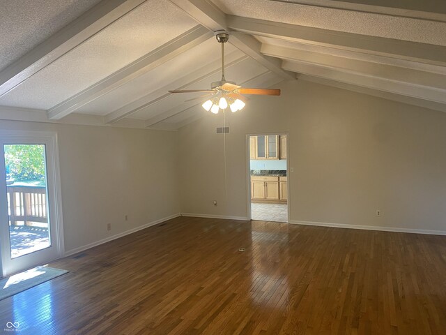 interior space featuring vaulted ceiling, dark hardwood / wood-style flooring, ceiling fan, and a textured ceiling