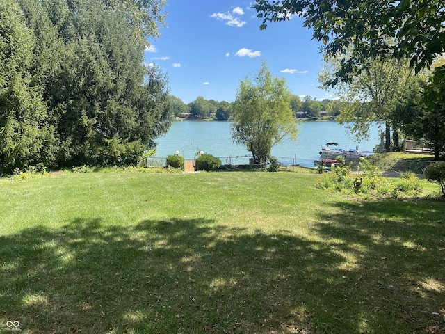 view of yard with a water view and fence