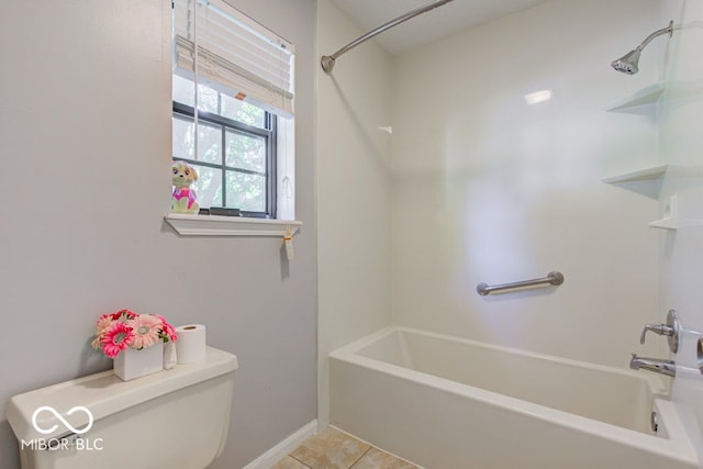 full bath with tile patterned flooring, toilet, shower / bathing tub combination, and baseboards