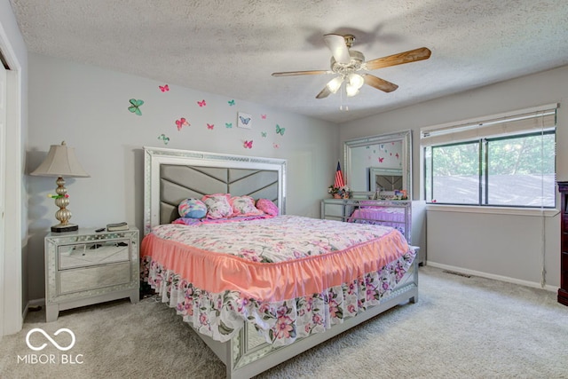 bedroom featuring carpet flooring, baseboards, visible vents, and a textured ceiling